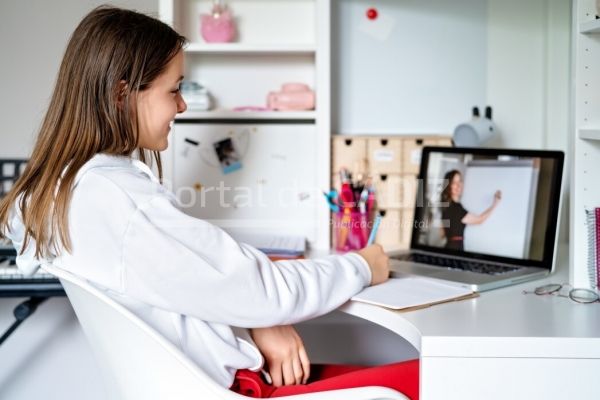 teenager girl studying online at home looking at teacher giving lesson at laptop screen at quarantine t20 gl0jrn