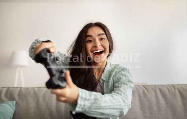 cheerful indian woman enjoying videogame on playst 2022 10 07 01 49 07 utc